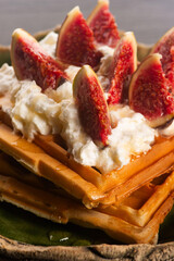 Waffles with figs, maple syrup, topped with whipped cream