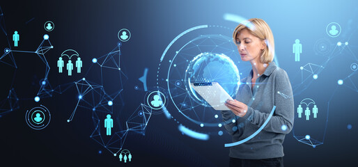 Woman using a tablet surrounded by digital network holograms and