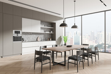 Modern kitchen interior with a sleek dining table and chairs, large windows, and a view of the city skyline. Minimalistic and spacious design. 3D Rendering