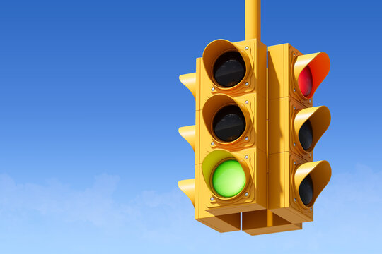 Yellow traffic light with a green signal illuminated, set against a clear blue sky. Concept of future coming, traffic control, and road safety. 3D Rendering