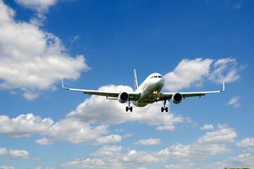 White passenger airplane flying in the sky amazing clouds in the background - Travel by air transport. High quality photo