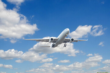 White passenger airplane flying in the sky amazing clouds in the background - Travel by air transport. High quality photo