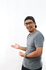 Asian man with beard wearing casual t-shirt and glasses over white background Inviting to enter smiling natural with open hand