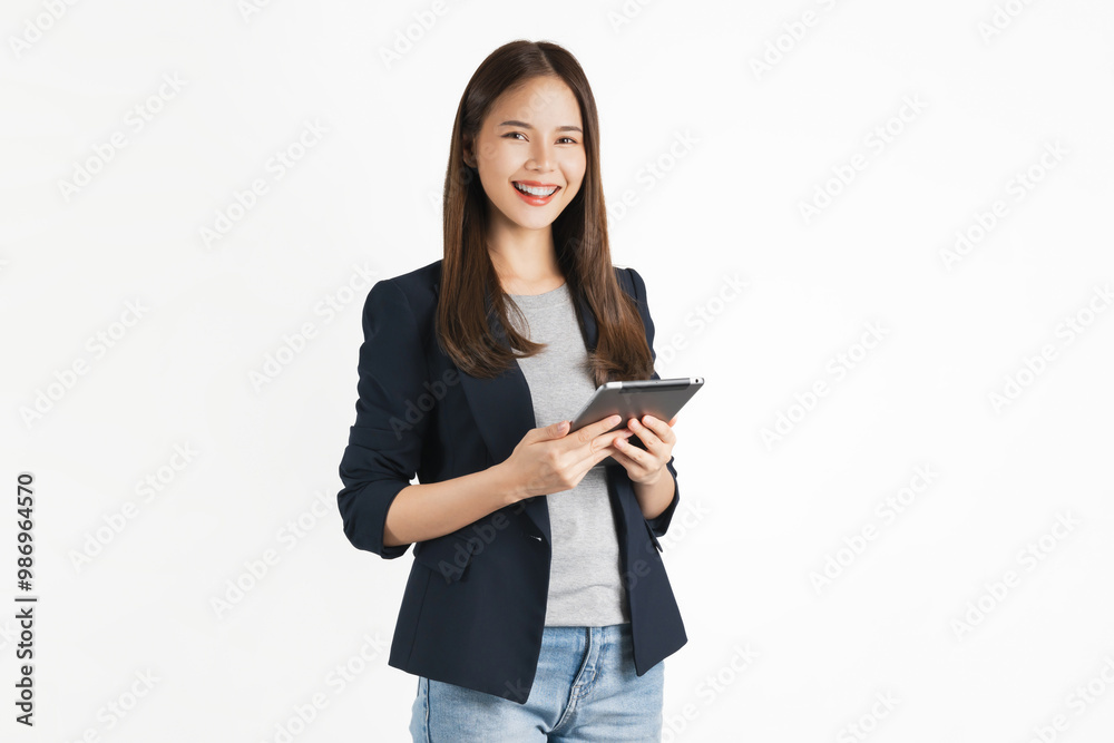 Wall mural studio shot of beautiful asian businesswoman holding digital tablet and smiling on white background.