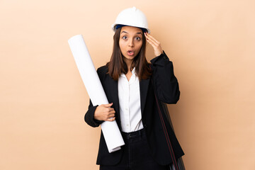 Young architect woman holding blueprints over isolated background has realized something and intending the solution