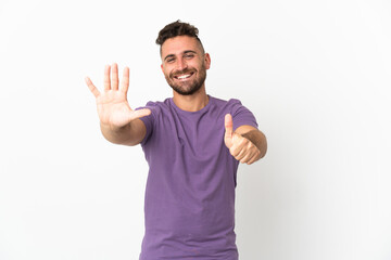Fototapeta premium Caucasian man isolated on white background counting six with fingers