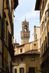 Florence, Palazzo Vecchio tower. View from a traditional street.