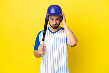 Young caucasian man playing baseball isolated on yellow background frustrated and covering ears