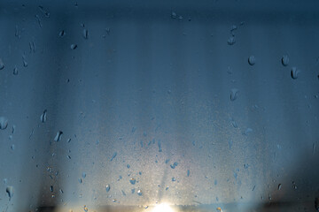 water droplets running on a double glazed window
