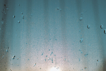 water droplets running on a double glazed window