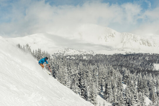 Skier at Monarch Mountain resort skiing powder