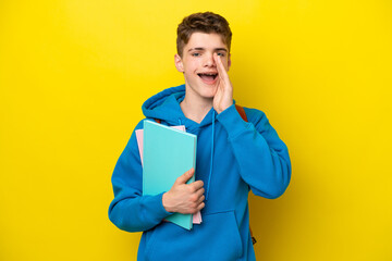 Teenager Russian student man isolated on yellow background shouting with mouth wide open