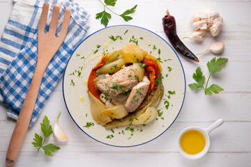 Baked mackerel with escalivada vegetables, peppers, onions and eggplant. Top view table with decoration.