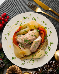 Baked mackerel with escalivada vegetables, peppers, onions and eggplant. Top view table with Christmas decoration.
