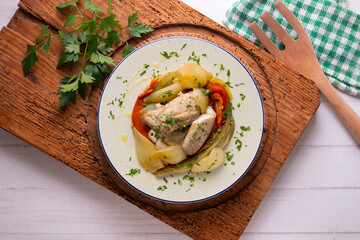 Baked mackerel with escalivada vegetables, peppers, onions and eggplant. Top view table with decoration.