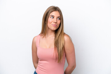 Fototapeta premium Young caucasian woman isolated on white bakcground having doubts while looking side
