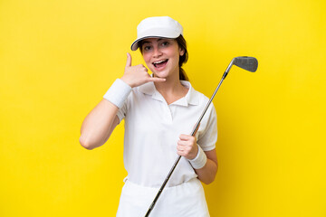 young caucasian woman playing golf isolated on yellow background making phone gesture. Call me back...