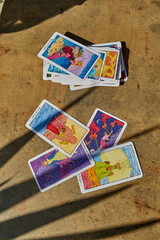 PALMA, SPAIN-August 29,2024;scattered on a textured surface, casting shadows, symbolizing mystery, spirituality, and divination through tarot card readings
