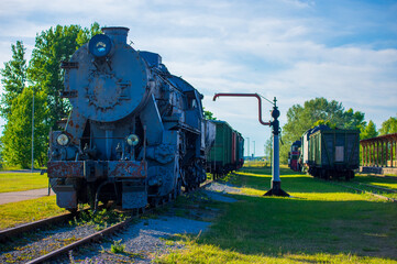 Historic Steam Locomotive on Display at a Train Station