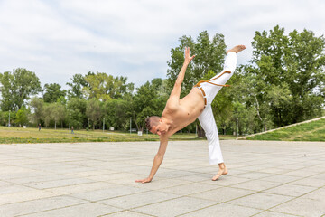 Middle aged man practicing capoeira , brazilian martial art