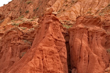 Fototapeta premium Northern Kyrgyzstan. The unusual texture of red-yellow clay rocks in the famous Skazka Canyon, off the coast of Lake Issyk-Kul.