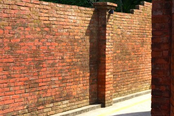 old brick wall in an alley on sunny day
