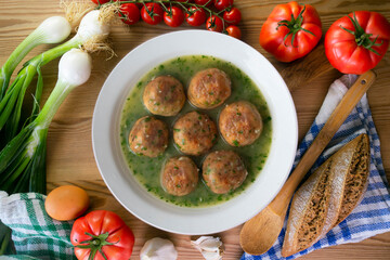 Fish meatballs with green parsley sauce. Top view table with  decoration.