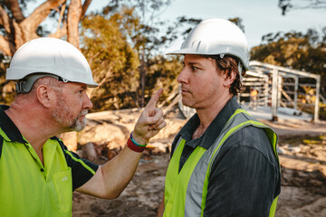 Two building contractors in a heated argument at the construction site.