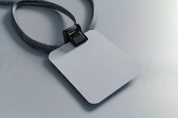 Fototapeta premium A white tag with a black clip attached to a silver chain