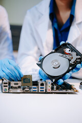 Obraz premium Technician repairing inside of hard disk drive by screwdriver. the concept of data, hardware, technician