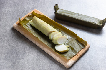 Lontong, rice rolled in banana leaves and boiled. Indonesian traditional food. Perfect for recipe, article, catalogue, commercial, or any cooking content.