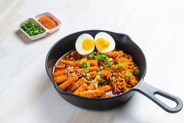 Korean instant noodles with Korean rice cake and fish cake and boiled egg - Rabokki - Korean food style. Perfect for recipe, article, catalogue, commercial, or any cooking content.