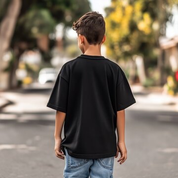 Kids black oversized tshirt, back view mockup. Schoolar age boy model wearing basic crewneck t-shirt mock up. Teenager's regular shirt, back side of casual tee, young urban lifestyle. Summer street