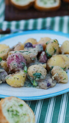 boiled potato salad with sour cream on the table in a plate
