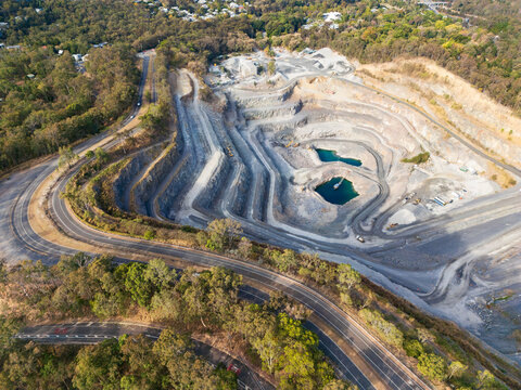 A quarry in the side of Mount Coot-tha with a road wrapping around the quarry