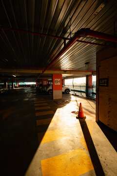 Multi storey car park in the city with afternoon sun shining on row of parked cars