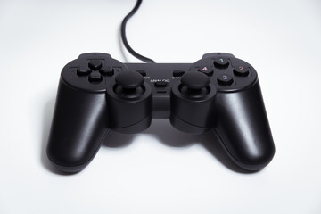 Black controller on white background, Video game device, Joystick on a white background. © Jong