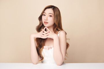Beautiful young asian woman with clean fresh skin on beige background, Face care, Facial treatment, Cosmetology, beauty and spa, Asian women portrait.