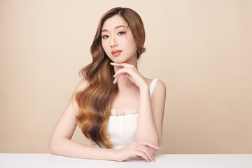 Naklejka premium Beautiful young asian woman with clean fresh skin on beige background, Face care, Facial treatment, Cosmetology, beauty and spa, Asian women portrait.