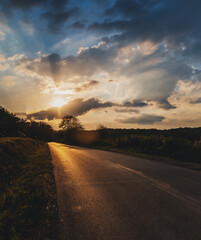 Road in the countryside in nature at sunset, travel landscape nature