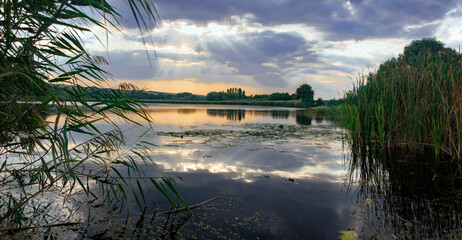 Evening, sunset sky on the lake.Hot, fishing spots. Fishing spots in a recreational area. Landscape park. 