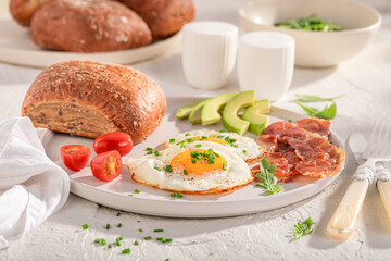 Delicious and crisp breakfast with fried eggs and buns.