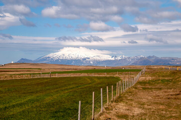 Snaefellsnes Peninsula Iceland, view across farm land to snow covered Sn&aelig;fellsjokull volcano
