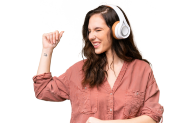 Young caucasian woman over isolated background listening music and dancing