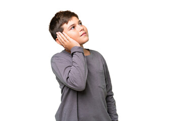 Little caucasian kid over isolated chroma key background thinking an idea