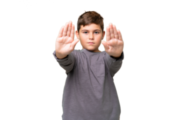 Little caucasian kid over isolated chroma key background making stop gesture and disappointed