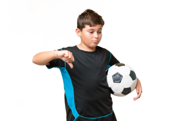Little caucasian football player kid over isolated chroma key background showing thumb down with negative expression