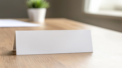A clean, white nameplate placed on a wooden desk, perfect for office settings and professional environments.