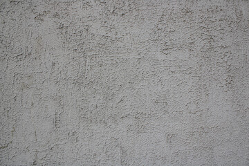 This is a detailed close-up of a gray wall full of tiny dots on it
