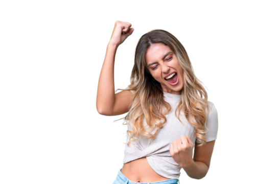 Young Uruguayan woman over isolated background celebrating a victory - Powered by Adobe